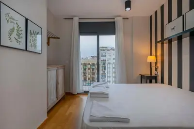 a bathroom with a toilet and a bedroom with a bed at The Collection Barcelona - Modern and bright apartment in Eixample 5-1 in Barcelona