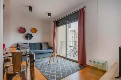 a quotationatory logo with a magnifying glass at The Collection Barcelona - Modern and bright apartment in Eixample 5-1 in Barcelona