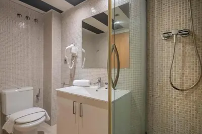 a bathroom with a toilet and a sink and a shower at The Collection Barcelona - Modern and bright apartment in Eixample 5-2 in Barcelona