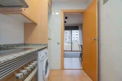 a kitchen with a dishwasher and a washer at The Collection Barcelona - 2 bedroom with balcony in Eixample 1-1 in Barcelona