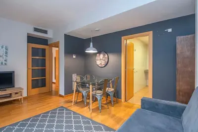 a room with a bathroom with a toilet and a bedroom at The Collection Barcelona - 2 bedroom with balcony in Eixample 1-1 in Barcelona