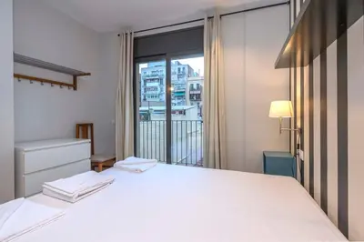 a kitchen with a washing machine and a microwave at The Collection Barcelona - 2 bedroom with balcony in Eixample 1-1 in Barcelona
