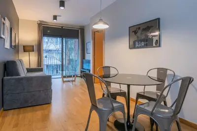 a living room with a table and chairs and a couch at The Collection Barcelona - Modern and bright apartment in Eixample 1-3 in Barcelona