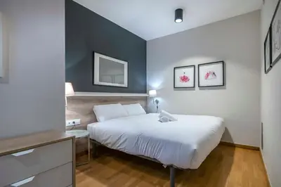 a living room with a television and a dining room at The Collection Barcelona - Modern and bright apartment in Eixample 1-3 in Barcelona