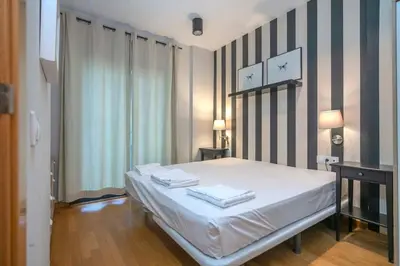 a bedroom with a bed with two towels on it at The Collection Barcelona - Modern and bright apartment in Eixample 2-1 in Barcelona
