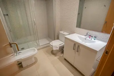 a bathroom with a shower and a toilet and a sink at The Collection Barcelona - Modern and bright apartment in Eixample 2-1 in Barcelona