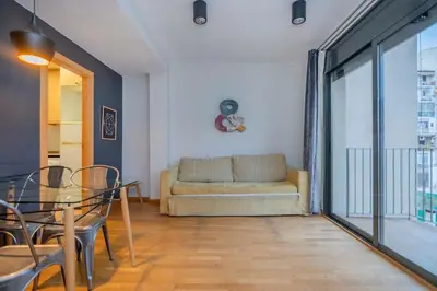 a bedroom with a large bed and a large window at The Collection Barcelona - Modern and bright apartment in Eixample 2-1 in Barcelona