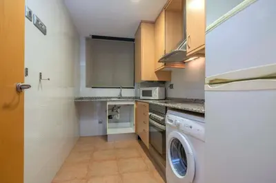 a kitchen with a washer and a washing machine at The Collection Barcelona - Modern and bright apartment in Eixample 2-1 in Barcelona