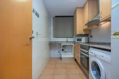 a kitchen with a washing machine and a washer at The Collection Barcelona - Modern and bright apartment in Eixample 2-1 in Barcelona