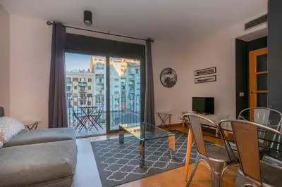 a living room with a couch and a table at The Collection Barcelona - Modern and bright apartment in Eixample 3-1 in Barcelona