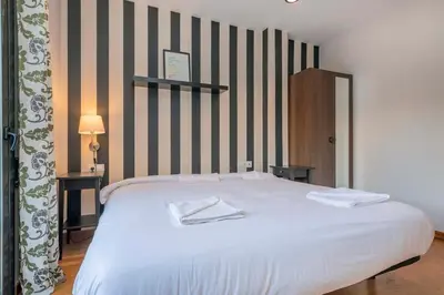 a bathroom with a white toilet and a sink at The Collection Barcelona - Modern and bright apartment in Eixample 3-1 in Barcelona