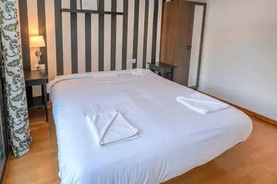 two beds in a room with a window at The Collection Barcelona - Modern and bright apartment in Eixample 3-1 in Barcelona