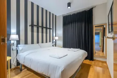 a bedroom with a large white bed and a window at The Collection Barcelona - 2 bedroom with balcony in Eixample 3-2 in Barcelona
