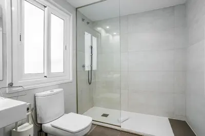 a bathroom with a shower and a toilet and a sink at The Collection Barcelona - Big apartment for 15 in the heart of Eixample in Barcelona