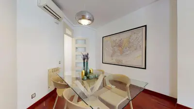 a dining room with a glass table and chairs at The Collection Barcelona - Modern and bright three-bedroom in Eixample in Barcelona