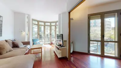 a living room with a couch and a tv at The Collection Barcelona - Modern and bright three-bedroom in Eixample in Barcelona