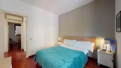 a bedroom with a large bed with a blue blanket at The Collection Barcelona - Modern and bright three-bedroom in Eixample in Barcelona