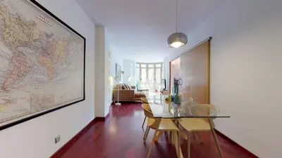 a dining room with a glass table and a map on the wall at The Collection Barcelona - Modern and bright three-bedroom in Eixample in Barcelona