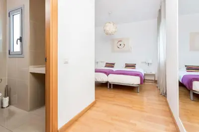 a hallway with two beds in a room with a mirror at The Collection Barcelona - Spacious and Elegant 4 Bedroom with Private Terrace in Barcelona