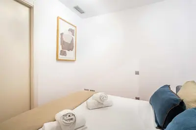 a bedroom with a bed with towels on it at The Collection Barcelona - Pl Universitat Comfortable 3BD with private patio in Barcelona
