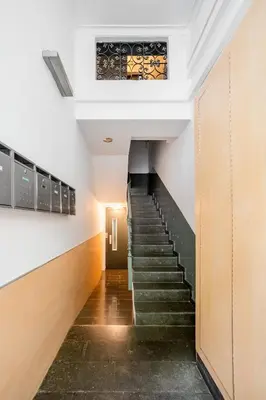 a staircase in a building with a stained glass window at The Collection Barcelona - Pl Universitat Comfortable 3BD with private patio in Barcelona