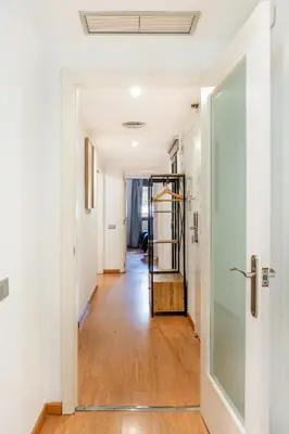 a hallway with white walls and a glass door at The Collection Barcelona - Pl Universitat Comfortable 3BD with private patio in Barcelona