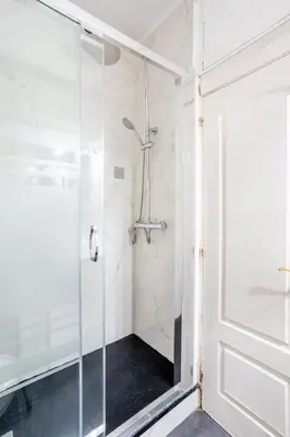 a shower with a glass door in a bathroom at The Collection Barcelona - Next to Sagrada Familia 4-bedroom Apartment in Barcelona