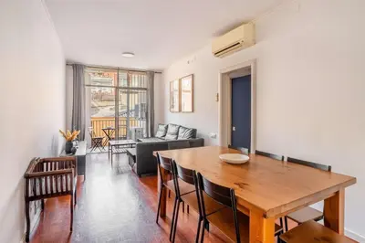 a dining room and living room with a table and chairs at The Collection Barcelona - Next to Sagrada Familia 4-bedroom Apartment in Barcelona