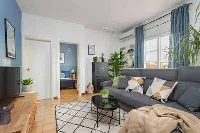 a living room with a couch and a table at The Collection Barcelona - City View Penthouse - 2 Bedroom Suite in Barcelona