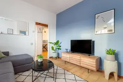 a living room with a couch and a flat screen tv at The Collection Barcelona - City View Penthouse - 2 Bedroom Suite in Barcelona