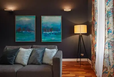 a living room with a couch and three paintings on the wall at The Collection Barcelona - Classy 3BD - 2BTH with private patio in Eixample in Barcelona