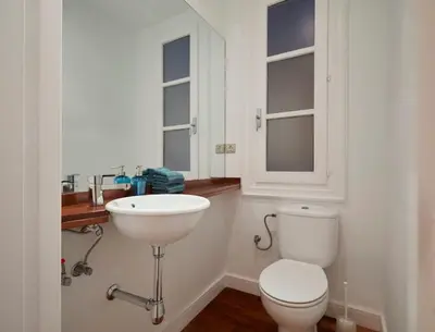 a bathroom with a white toilet and a sink at The Collection Barcelona - Classy 3BD - 2BTH with private patio in Eixample in Barcelona