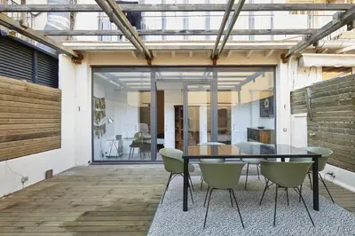 a dining room with a table and chairs on a patio at The Collection Barcelona - Classy 3BD - 2BTH with private patio in Eixample in Barcelona