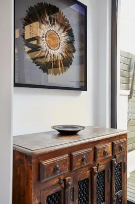 a wooden cabinet in a room with a picture on the wall at The Collection Barcelona - Classy 3BD - 2BTH with private patio in Eixample in Barcelona