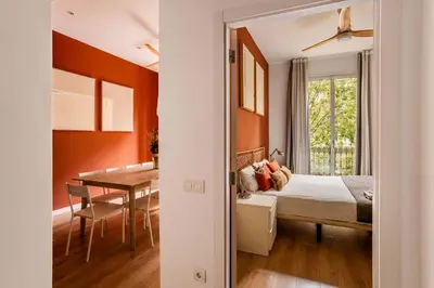 a bedroom with a bed and a dining room at The Collection Barcelona - Beautiful 4bd 4ba apartment in Eixample District in Barcelona