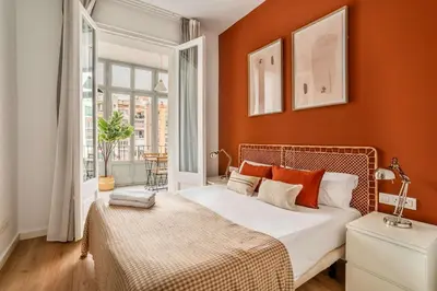a bedroom with orange walls and a bed with orange pillows at The Collection Barcelona - Beautiful 4bd 4ba apartment in Eixample District in Barcelona
