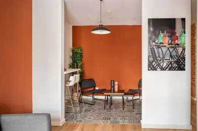 a dining room with orange walls and a table and chairs at The Collection Barcelona - Beautiful 4bd 4ba apartment in Eixample District in Barcelona