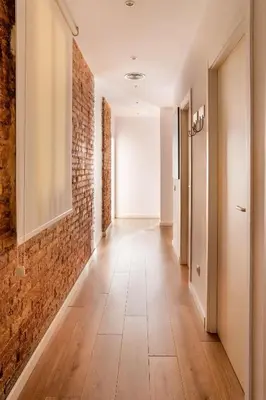 a corridor with a brick wall and a hallway with at The Collection Barcelona - Very Spacious Eixample 4bd 4ba apartment in Barcelona