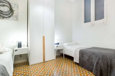 a small room with two beds and a closet at The Collection Barcelona - 4bedroom apart with balcony in Las Ramblas 1 1 in Barcelona