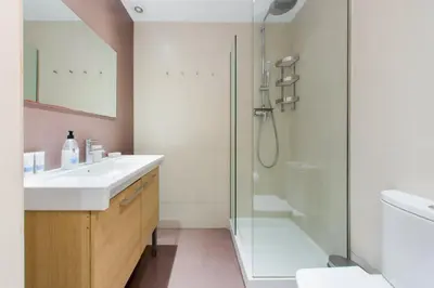 a bathroom with a glass shower and a sink at The Collection Barcelona - 4bedroom apart with balcony in Las Ramblas 1 1 in Barcelona