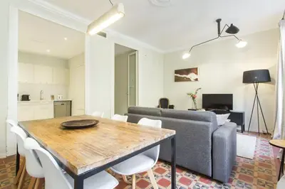 a city street with cars parked in front of buildings at The Collection Barcelona - 4bedroom apartment with a balcony in Las Ramblas 1 2 in Barcelona
