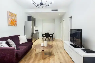 a quotationatory logo with a magnifying glass at The Collection Barcelona - Centric 3bedroom in Las Ramblas 2 1B in Barcelona