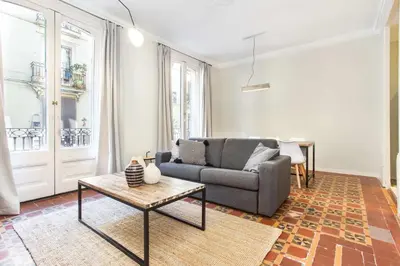 a living room with a couch and a table at The Collection Barcelona - 4bedroom apart with balcony in Las Ramblas 3-2 in Barcelona