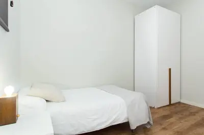 a white bed in a room with a window at The Collection Barcelona - Bright and modern 4bedroom with terrace in Las Ramblas P2 in Barcelona