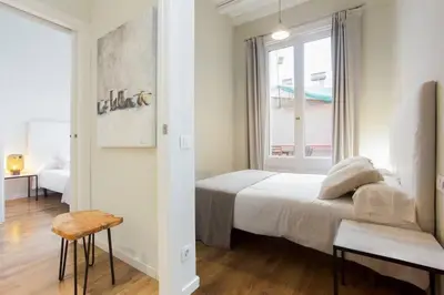 two twin beds with a desk in a room at The Collection Barcelona - Bright and modern 4bedroom with terrace in Las Ramblas P2 in Barcelona
