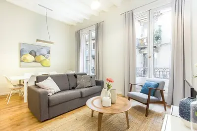 a living room with a couch and a table at The Collection Barcelona - Bright and modern 4bedroom with terrace in Las Ramblas P1 in Barcelona