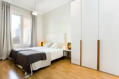 a bedroom with a bed and a desk in a room at The Collection Barcelona - Bright and modern 3bedroom in Las Ramblas 3 1B in Barcelona