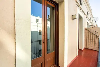 a living room with a dining room table with white chairs at The Collection Barcelona - Bright and modern 3bedroom in Las Ramblas 3 1B in Barcelona