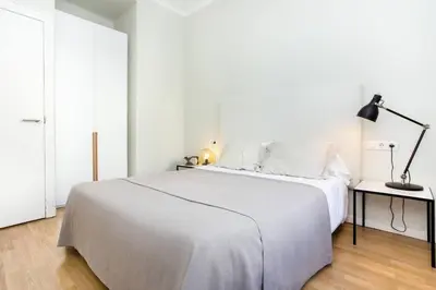 a quotationatory logo with a magnifying glass at The Collection Barcelona - Bright and modern 3bedroom in Las Ramblas 3 1B in Barcelona