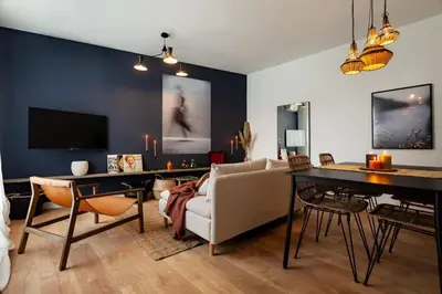 a living room with a couch and a table at The Collection Barcelona - Plaza Catalunya cozy 4 Bedroom in Barcelona